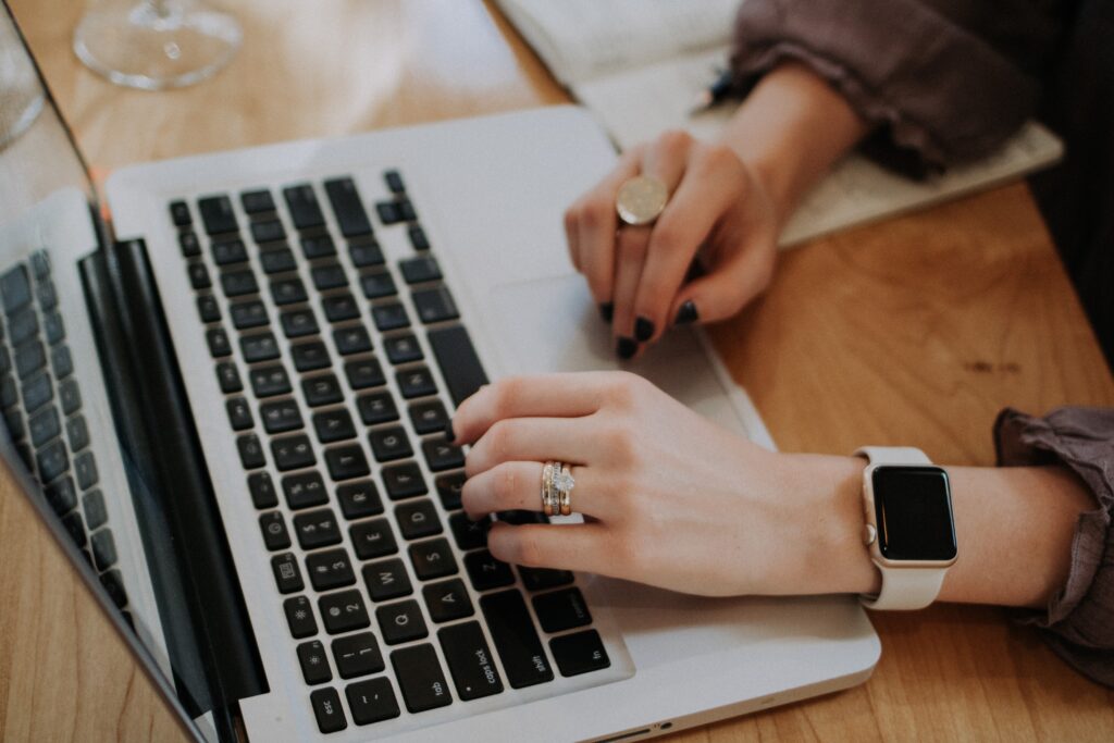 woman wearing apple watch using macbook for business